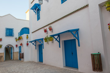 Yasmine Hammamet, TUNISIA - JULY 26 2018: White house with blue windows and doors and flowers, Yasmine Hammamet, Tunisia