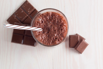 Chocolate, coffee, milk, banana shake on wooden background. Smoothie with mint. Milkshake. Protein diet. Healthy food and drink concept.