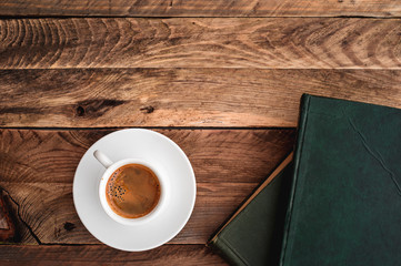 Panoramic top view on a coffee and books on wooden rustic table.