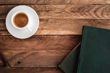 Cup of coffee and stack of old books.