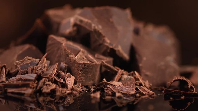 Chocolate. Chunks of sweet dark chocolate rotated closeup. Dessert ingredient. Confectionery. Rotation. 4K UHD video 3840X2160