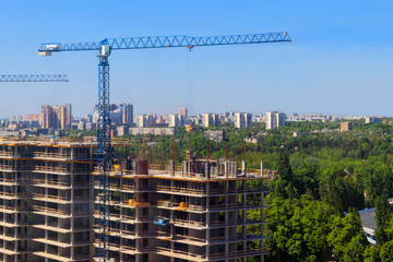 Fototapeta premium Building crane and house under construction
