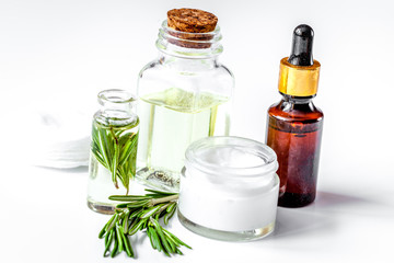organic cosmetics with extracts of herbs rosemary on white background