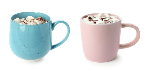Set of two different cups with sweet chocolate milk and marshmallows on white background
