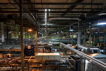 Industrial interior of soft drinks factory with tubes
