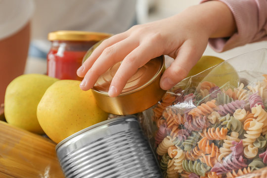 Girl Taking Food Out Of Donation Box, Closeup