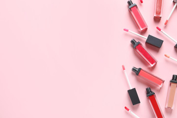 Beautiful flat lay composition of liquid lipsticks and space for text on color background