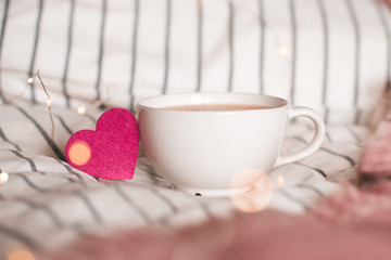 Cup of coffee with pink heart closeup. Valentines Day.