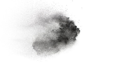 Black powder explosion on white background.Black dust particles splash.