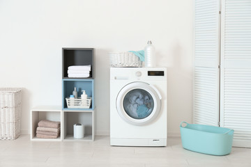 Washing of different towels in modern laundry room
