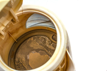 Scale, scales in an old teapot on white isolated background, the remainder of the Cretaceous deposits of calcium carbonate. The problem of hard water