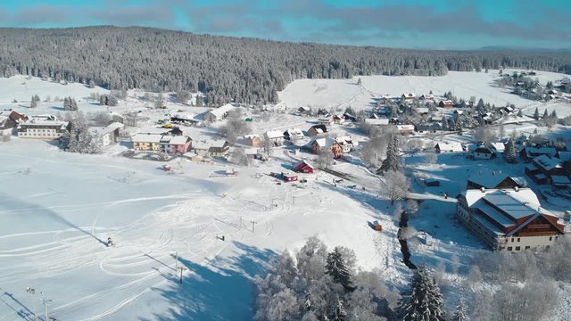 Snowfall of holls, forests and frozen river