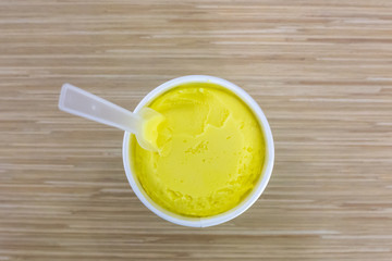yellow ice cream in a cup