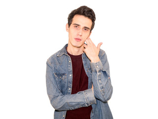 Young handsome man looking tired and bored with depression problems. isolated on grey background