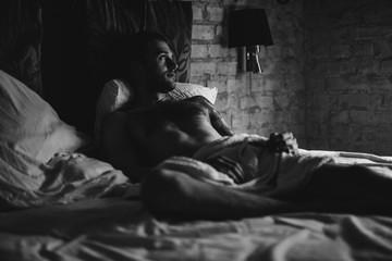 a man in bed wakes up