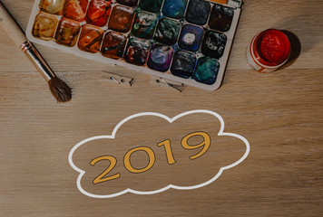 A pack of paints with a brush with an inscription 2019. Template
