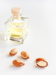 Bottle with valuable oil argan nuts. Cosmetic means. Food product. Jar with argan oil on the isolated background