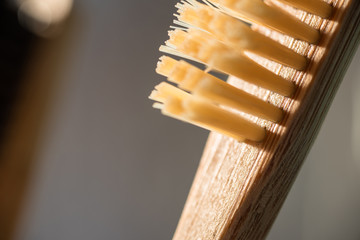 closeup view of eco-friendly bamboo toothbrush next to window in bathroom