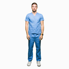 Fototapeta premium Handsome doctor man wearing medical uniform over isolated background with serious expression on face. Simple and natural looking at the camera.