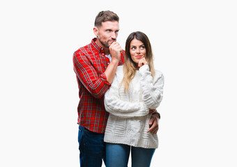 Young couple in love wearing winter sweater over isolated background with hand on chin thinking about question, pensive expression. Smiling with thoughtful face. Doubt concept.