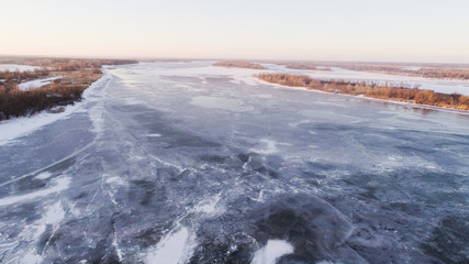 frozen river with small islands of trees , drone shoot, aireal photo 