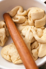 Rolling-pin and dough in a bowl. Prepare a sweet pastry to bake