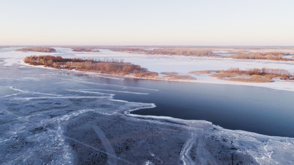 frozen river with small islands of trees , drone shoot, aireal photo 