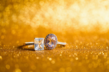 Jewelry diamond ring with abstract festive glitter Christmas holiday texture background blur with bokeh light