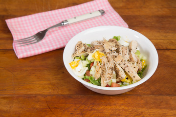 Blackend Chicken Breast Salad on Rustic Wooden Table with Pink Gingham Napkin