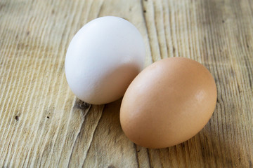 white and brown egg on a wooden board