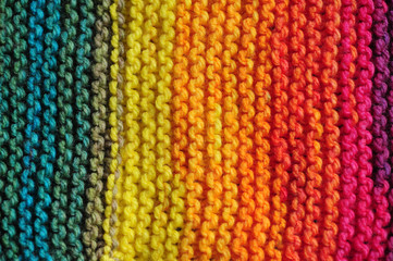 Close up of rows of seamless knitted patterns in vivid rainbow mixed colors