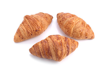 three crunchy croissants isolated on white background
