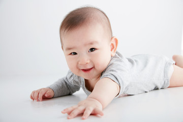 Closeup Asian baby lying on the clean ground
