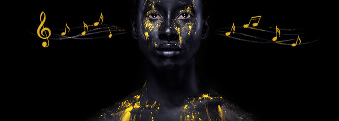 Art fashion makeup. Amazing afro american woman with black makeup and leaking gold paint and notes. Colorful art on body.