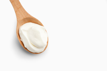 Fototapeta na wymiar Greek yogurt in wooden spoon, copy space