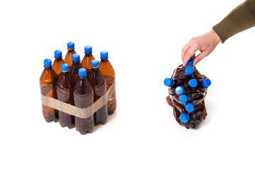 Hand holds nine plastic flat bottle