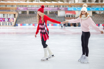 women ice skating outdoor at ice rink