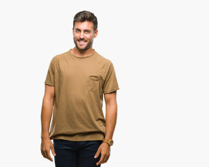 Obraz premium Young handsome man over isolated background looking away to side with smile on face, natural expression. Laughing confident.