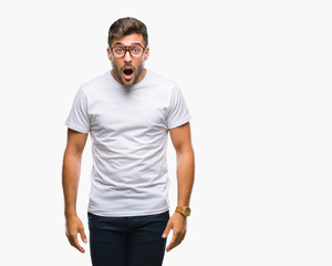 Fototapeta premium Young handsome man wearing glasses over isolated background afraid and shocked with surprise expression, fear and excited face.