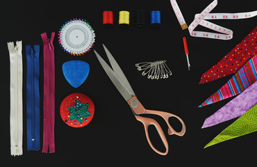 Fototapeta na wymiar sew elements, needles, scissors with black background