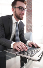 Portrait of successful businessman working in modern office