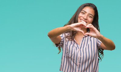 Young beautiful arab woman over isolated background smiling in love showing heart symbol and shape with hands. Romantic concept.