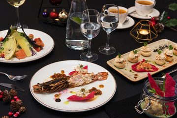 Tasty restaurant dishes: Cooked and stuffed crayfish, salad, appetizers, and crayfish ice-cream
