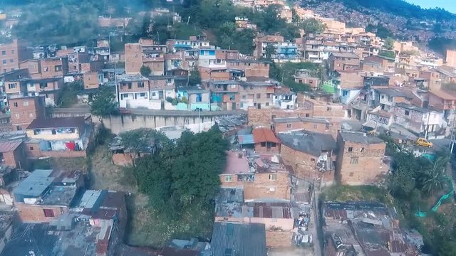 Slums of Medellin passing by seen from a cable car, colombian ghetto, top view above houses, South America, Colombia