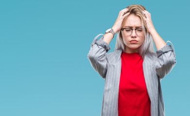 Young blonde business woman wearing fashion jacket over isolated background suffering from headache desperate and stressed because pain and migraine. Hands on head.