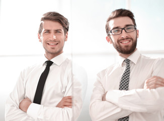 smiling business colleagues standing in a bright office