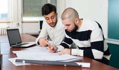 Students working with laptop at desk