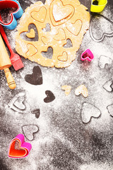 Obraz na płótnie Canvas Cookies in the shape of hearts, cooking. Valentine's Day. Flat lay.