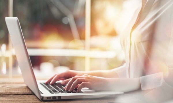 Woman typing computer.