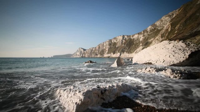 Waves on the beach at Worbarrow Bay on the Jurassic Coast in Dorset.
